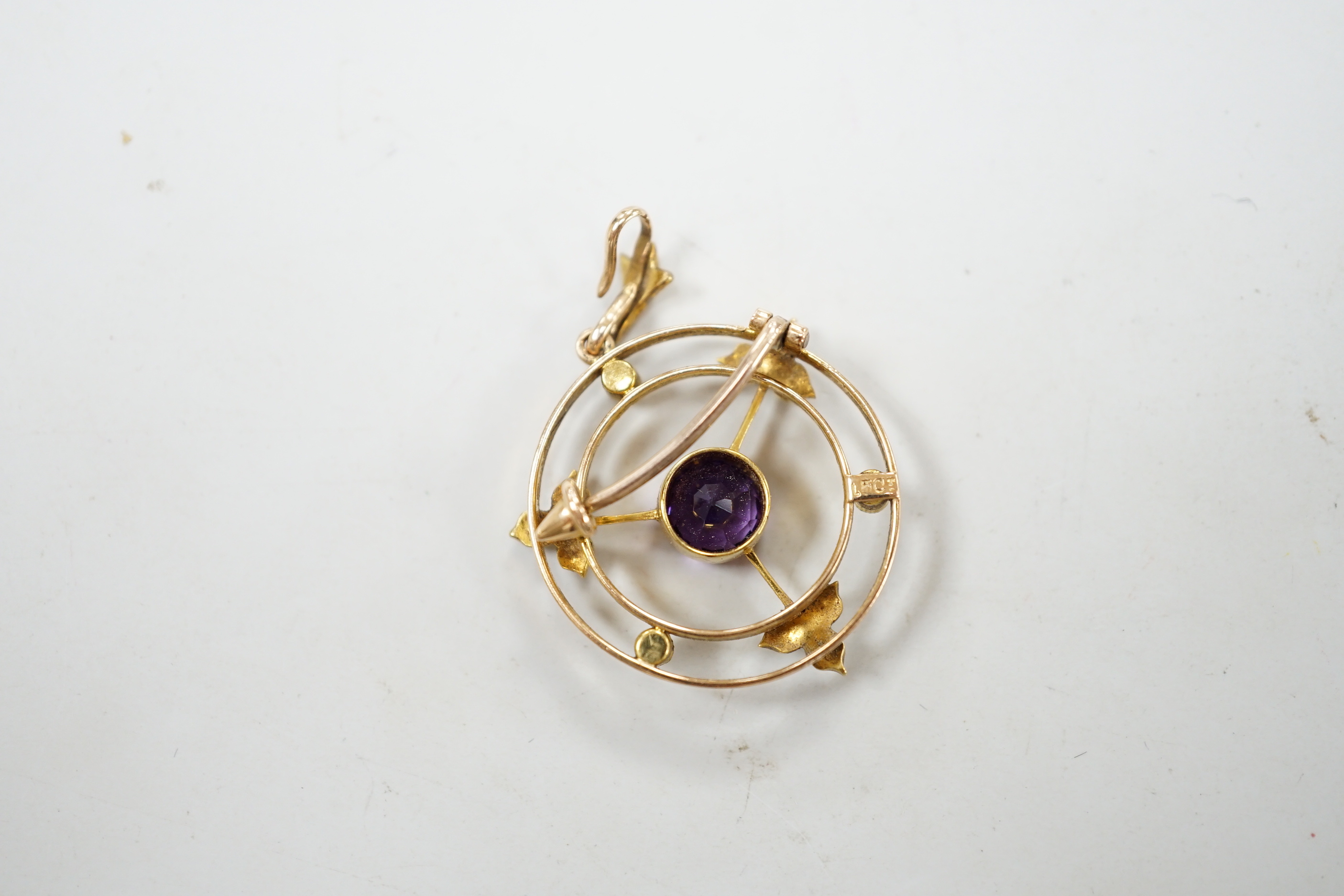 An Edwardian 15ct, amethyst and seed pearl set pendant brooch, overall 36mm, gross weight 4.1 grams, in fitted leather box.